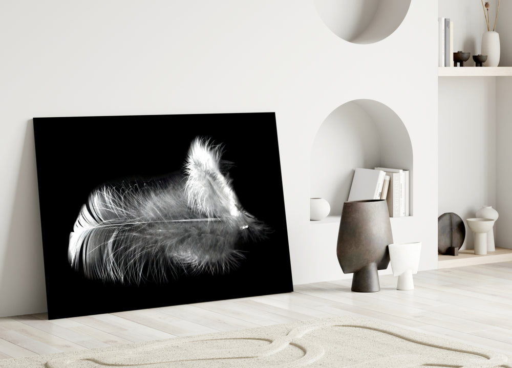 Feather glass wall art styled above a bed in a bedroom