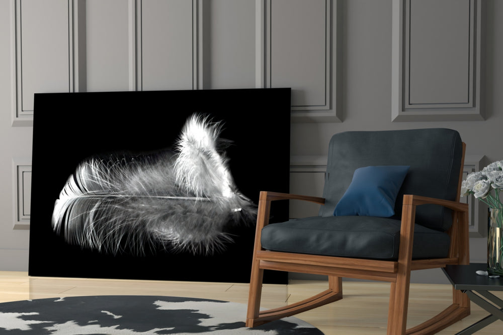Feather artwork anchoring a wall with moody serene palette