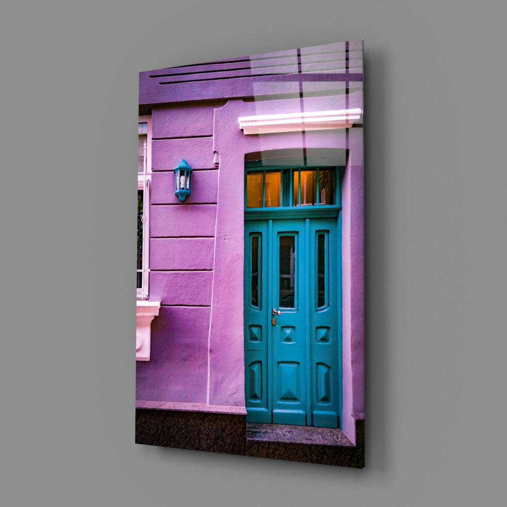 Close-up detail of teal door panels in violet stucco