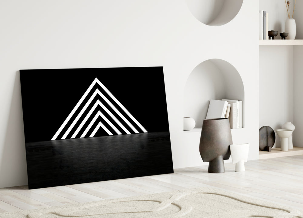 Triangle glass wall art styled above a desk in a creative office