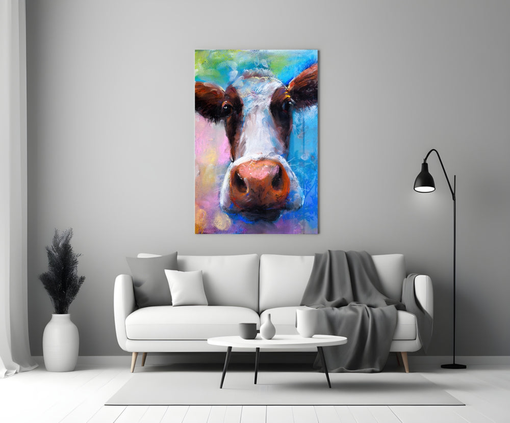 Painted Cow glass wall art styled above a sofa in a living room