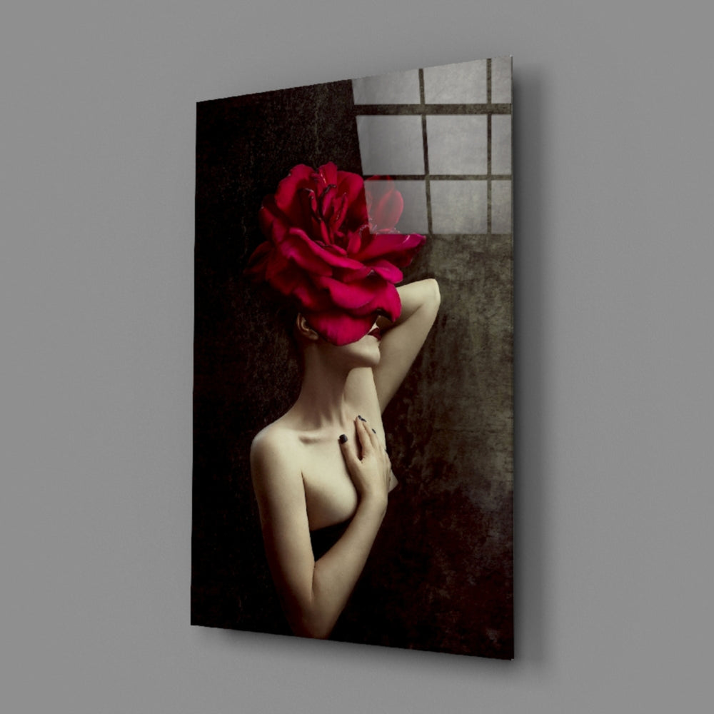 Close-up detail of crimson velvet rose against bare shoulder