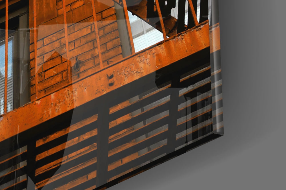 Orange Stairs panel catching window light to reveal its tactile rivet