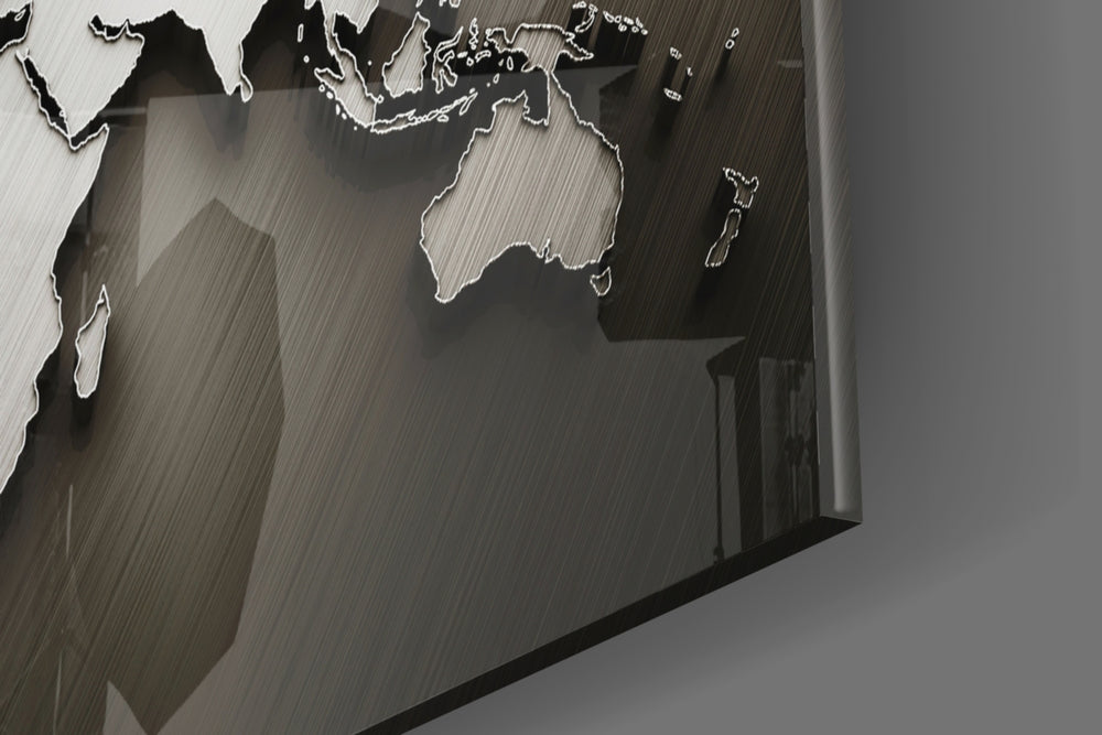 Chrome World Map panel catching brass-light to reveal its tactile relief