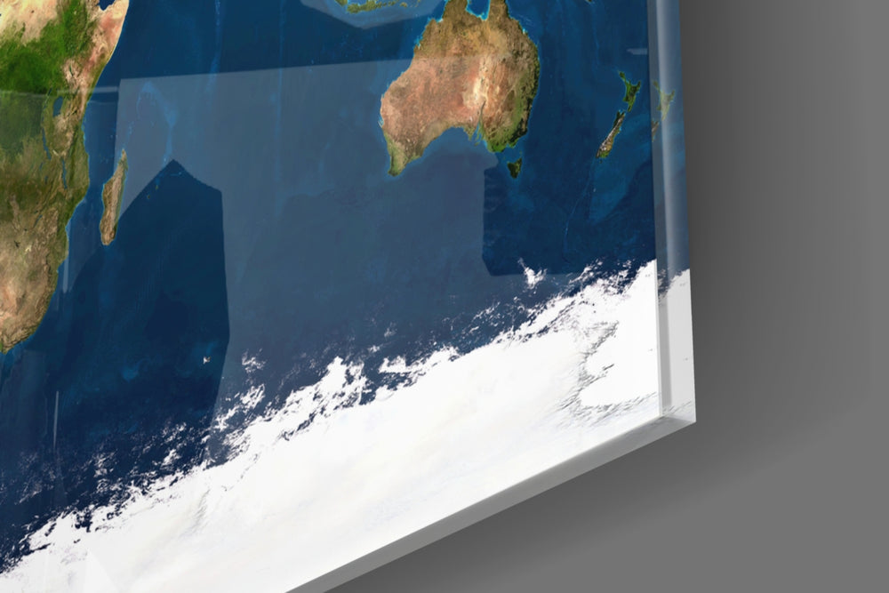 Satellite Earth panel catching window light to reveal its tactile texture