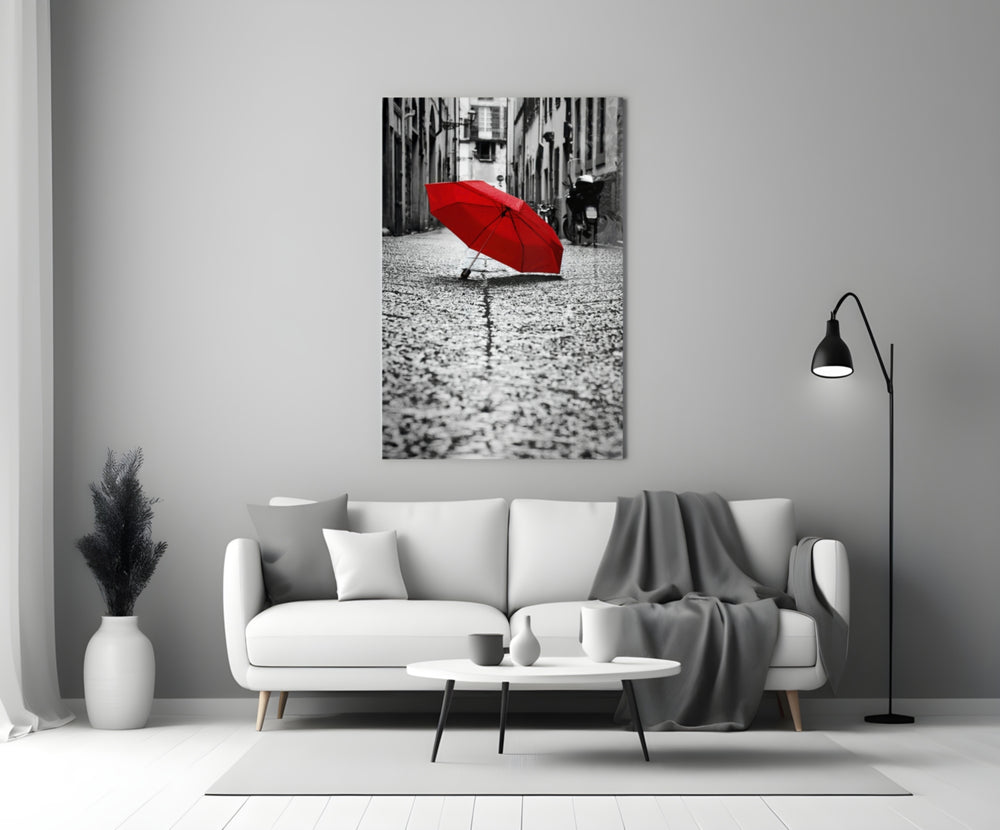 Red Umbrella glass wall art styled above a console in a hallway