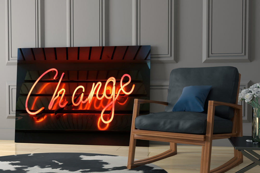 Change Neon artwork anchoring a wall with motivational modern palette