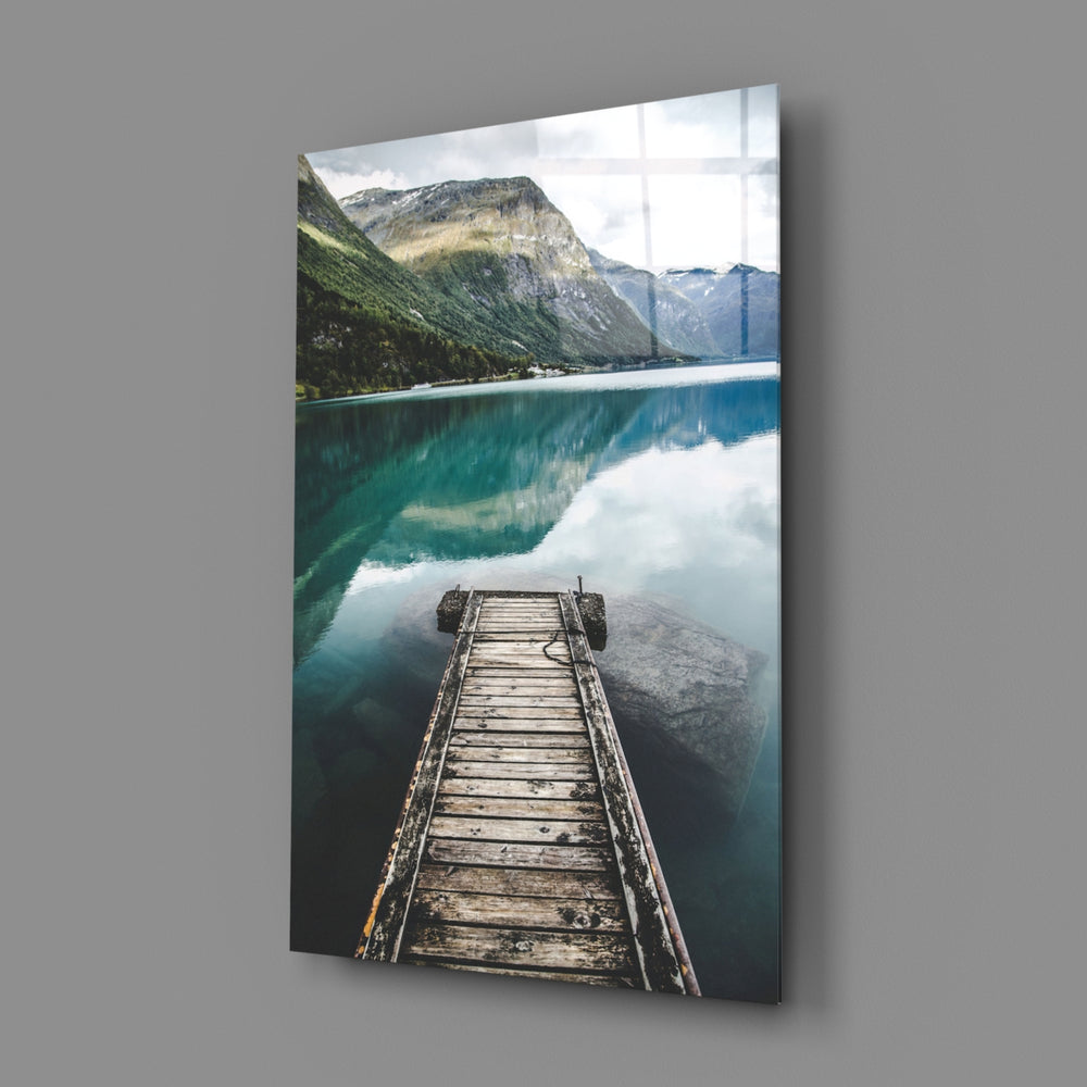 Dock close-up showing weathered planks above turquoise mirrored water