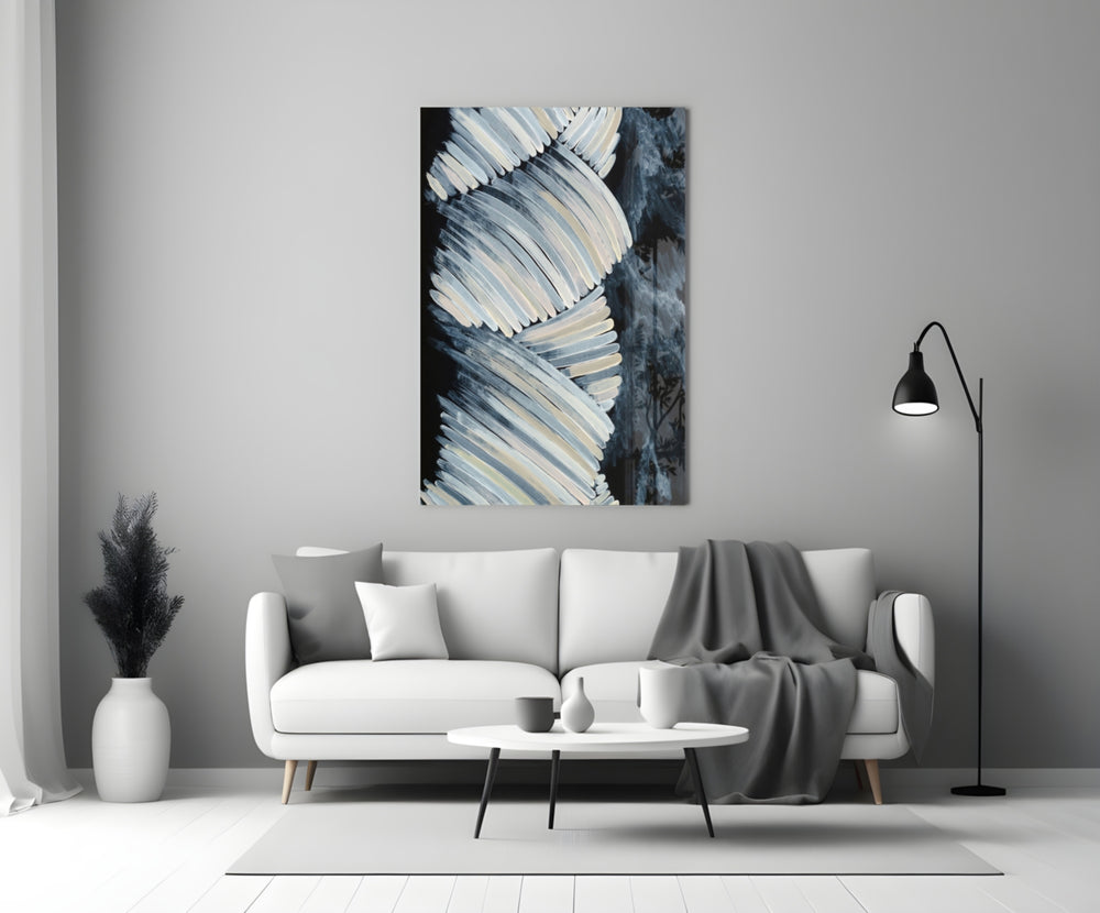 Abstract glass wall art styled above a coffee table in a living room