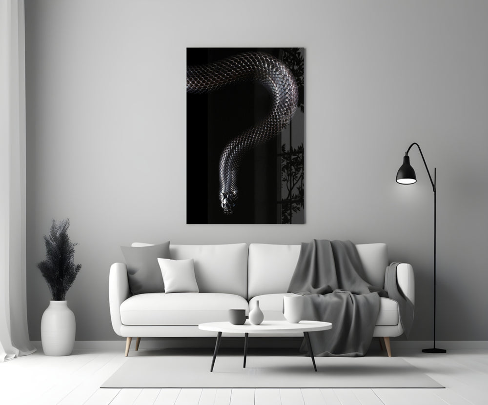 Snake glass wall art styled above a credenza in a gaming room