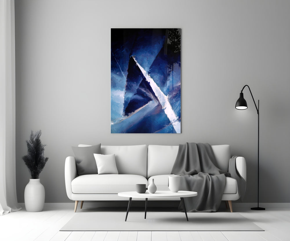 Abstract glass wall art styled above a credenza in a living room