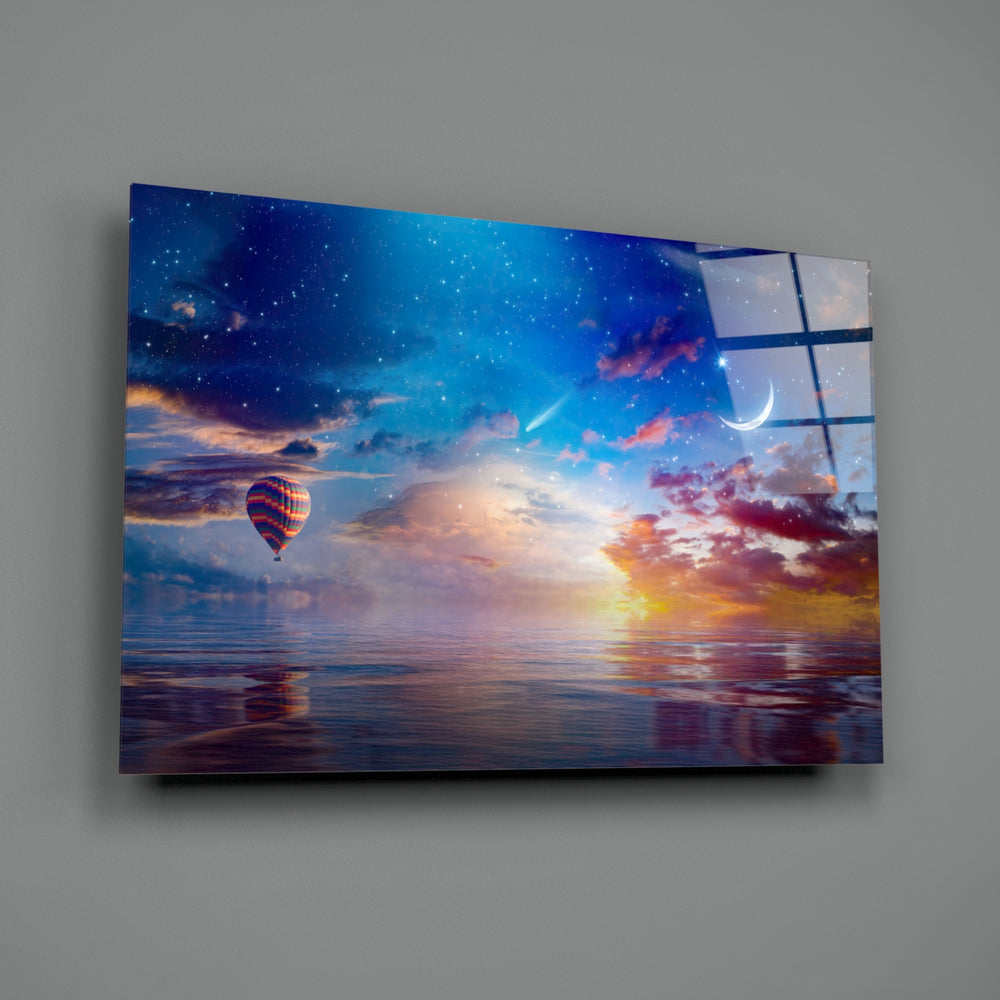 Landscape close-up showing crescent moon and balloon over coral sunset sea