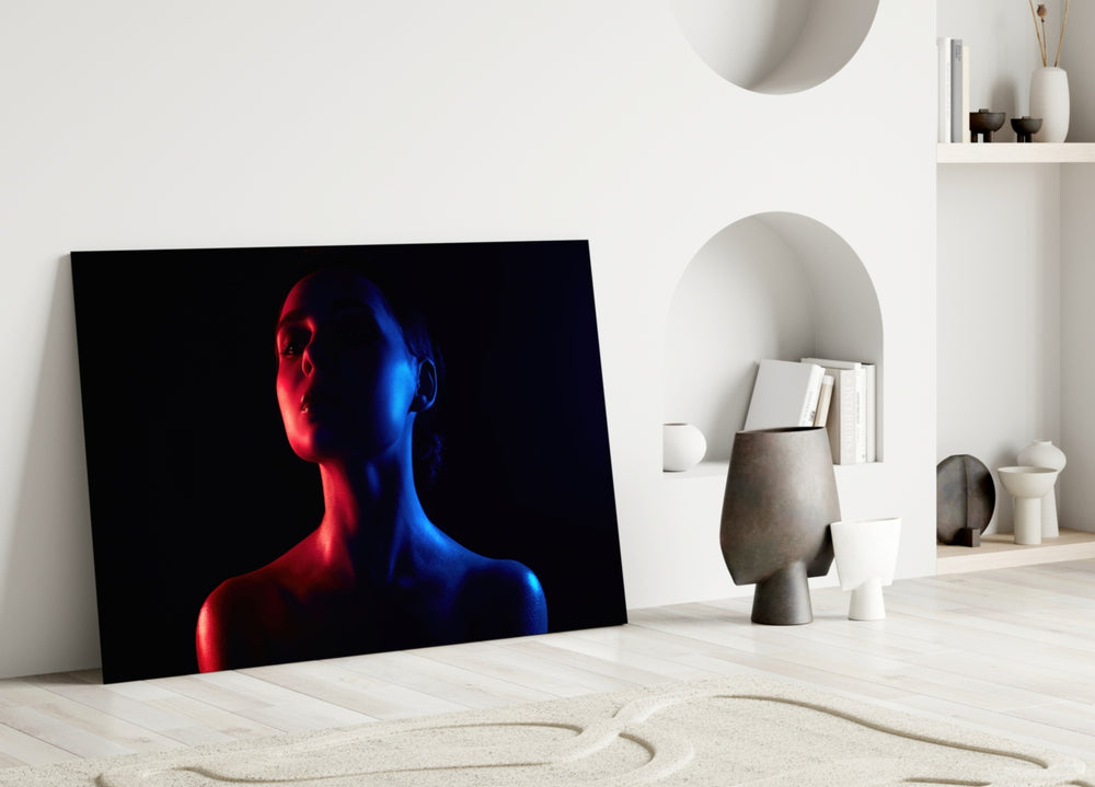 Women's glass wall art styled above a sofa in a bedroom