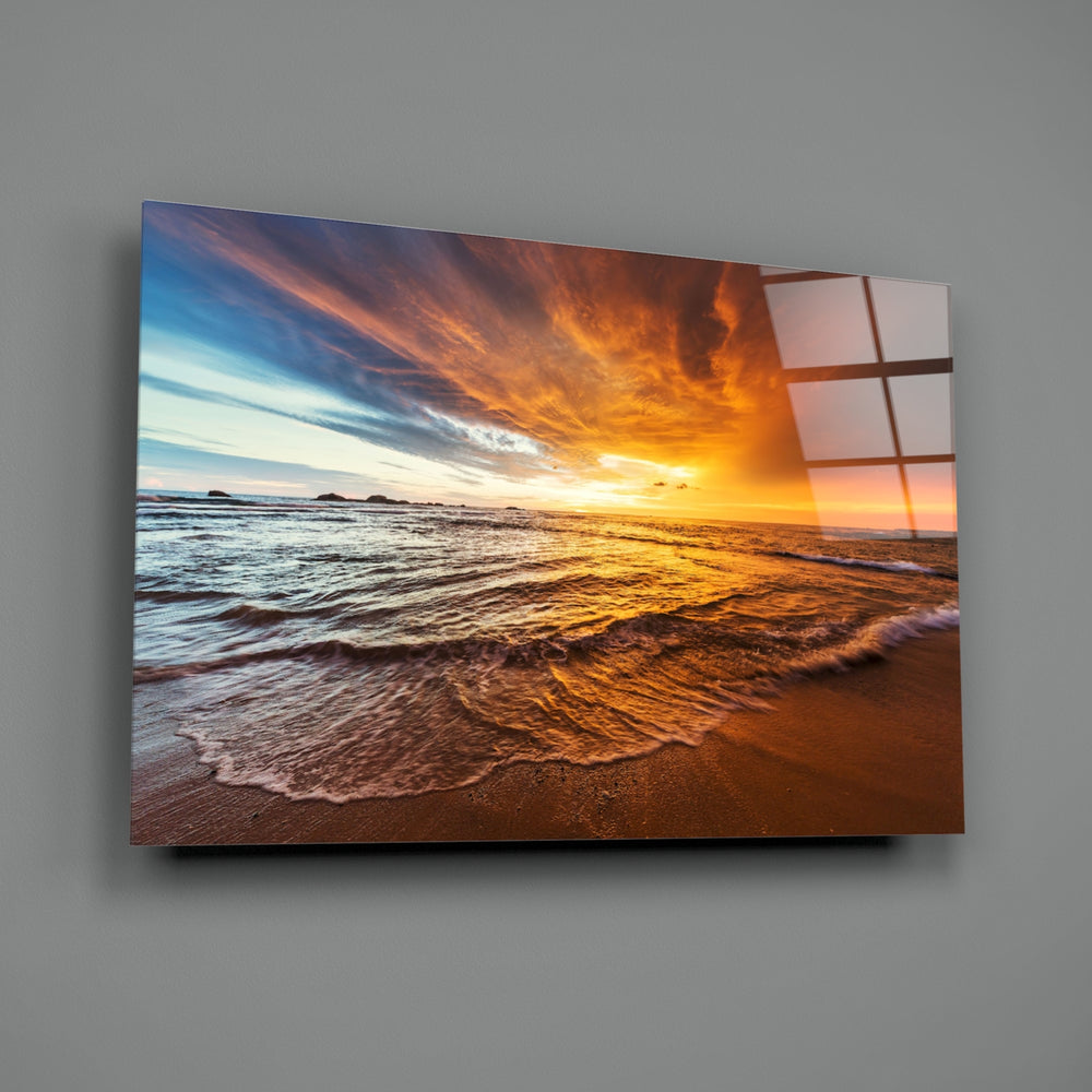 Sunset close-up showing amber sun sinking over rolling shore waves