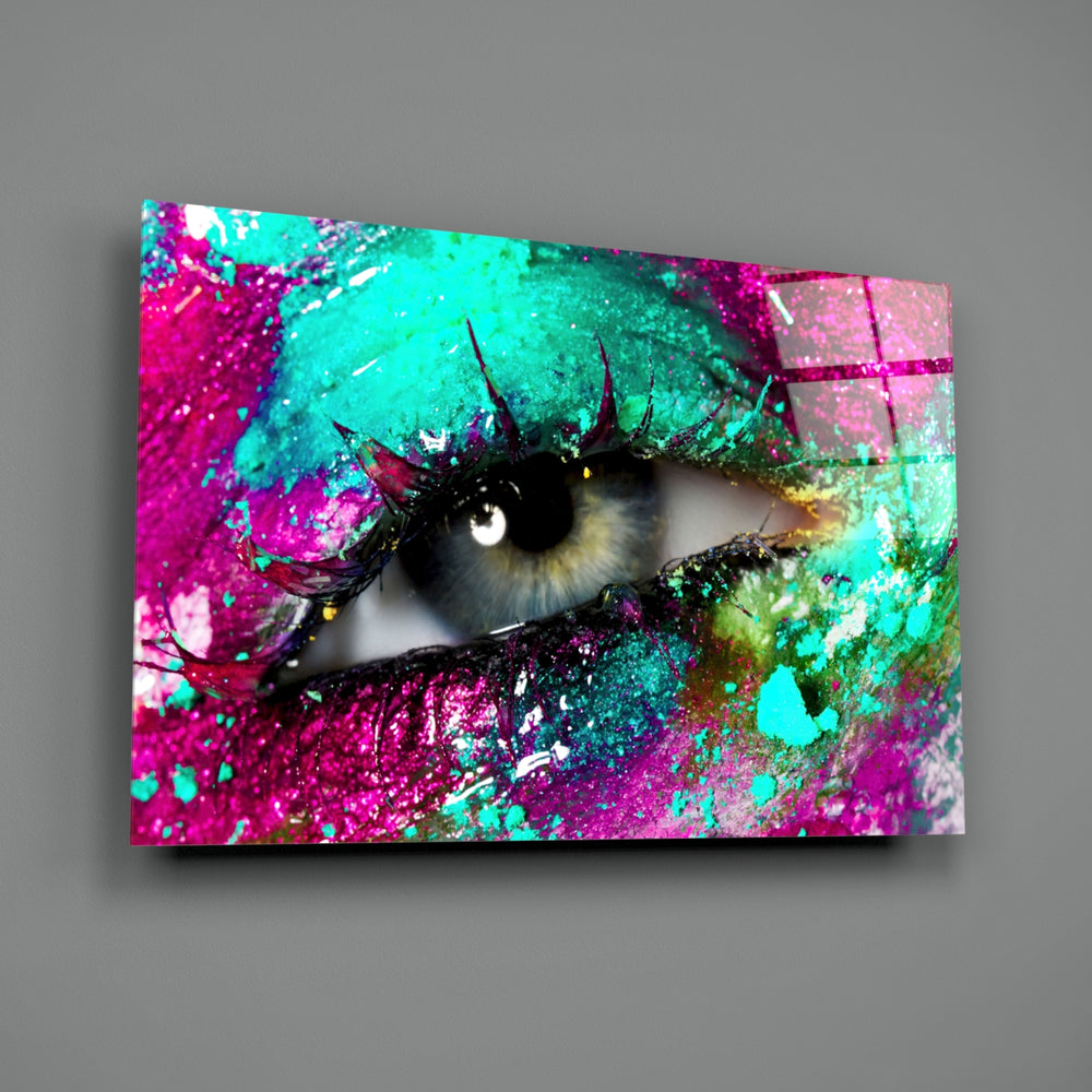 Pupil close-up showing eye through magenta and turquoise paint splash