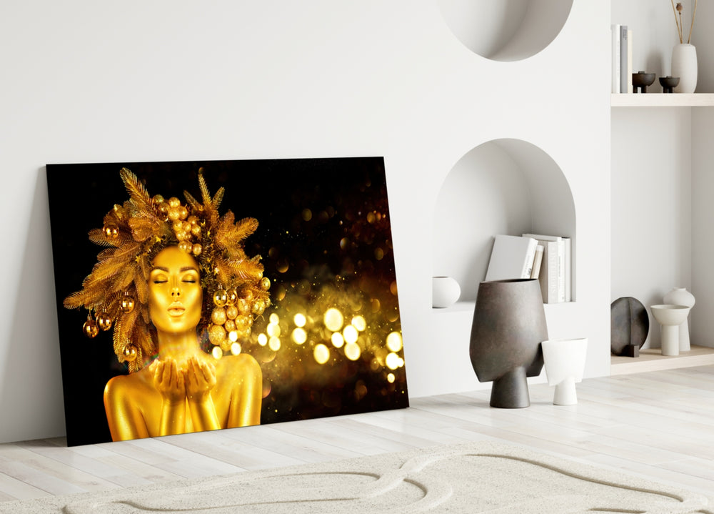 Gold Woman glass wall art styled above a credenza in a bedroom