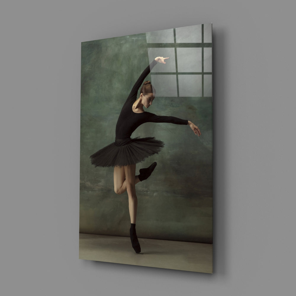 Ballerina close-up showing black-tutu dancer en pointe with arched arms