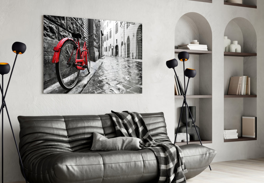 Street and Bicycle glass wall art styled above a sofa in a living room