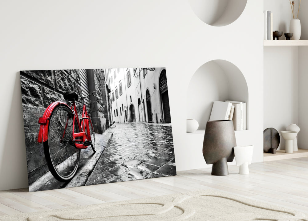 Street and Bicycle close-up showing red cruiser against rain-glazed cobblestone alley