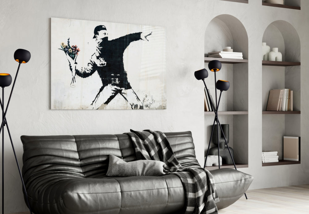 Transverse War glass wall art styled above a sofa in a living room