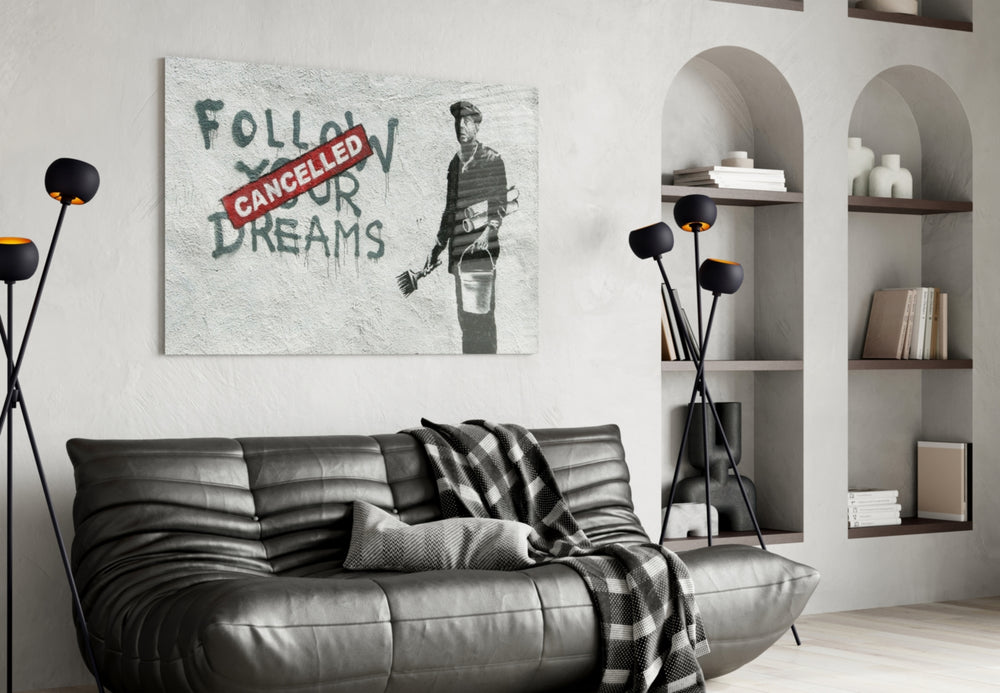 Plans Cancelled glass wall art styled above a desk in an office