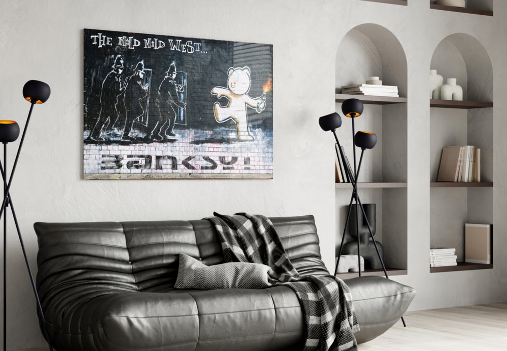 Bear's Resistance glass wall art styled above a sofa in a gaming room
