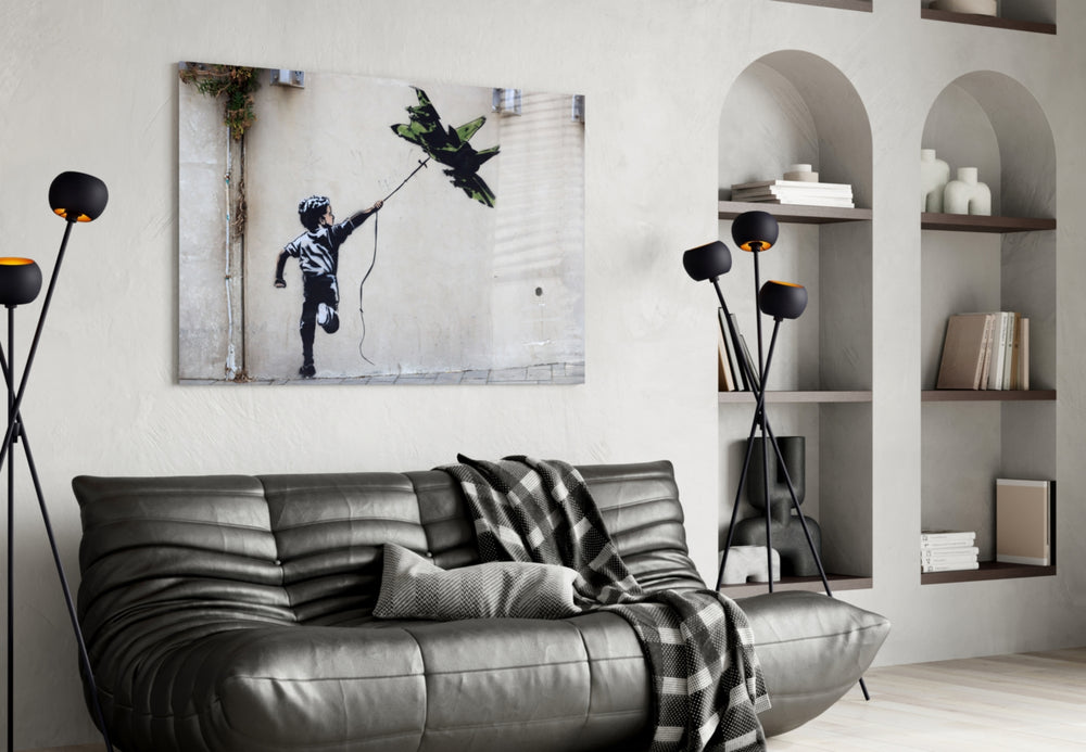 War Kite glass wall art styled above a sofa in a living room