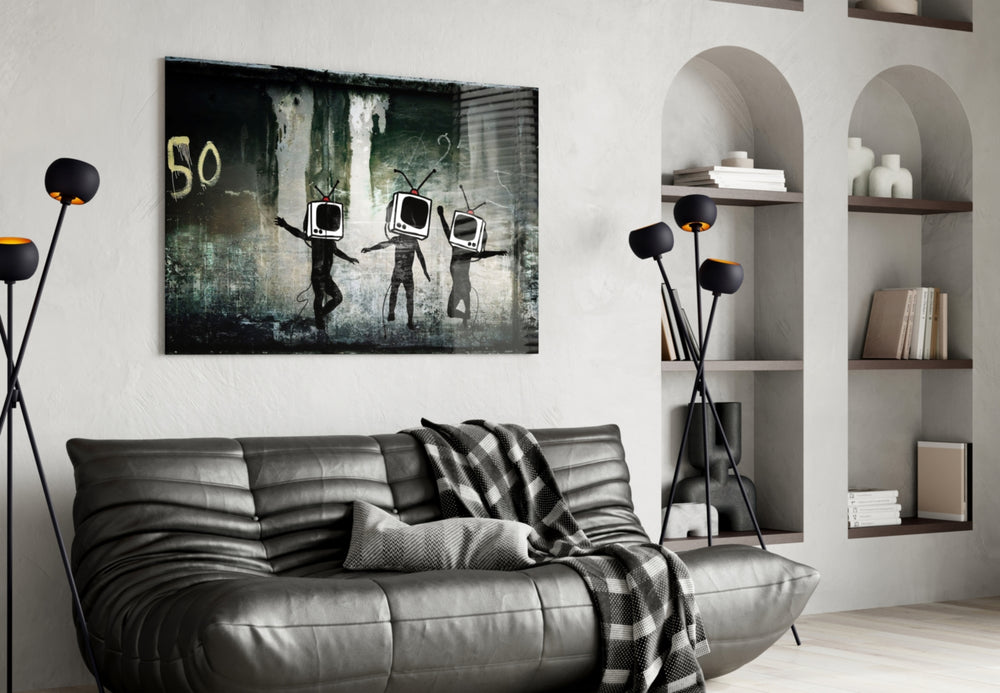 TV Heads glass wall art styled above a sofa in a gaming room