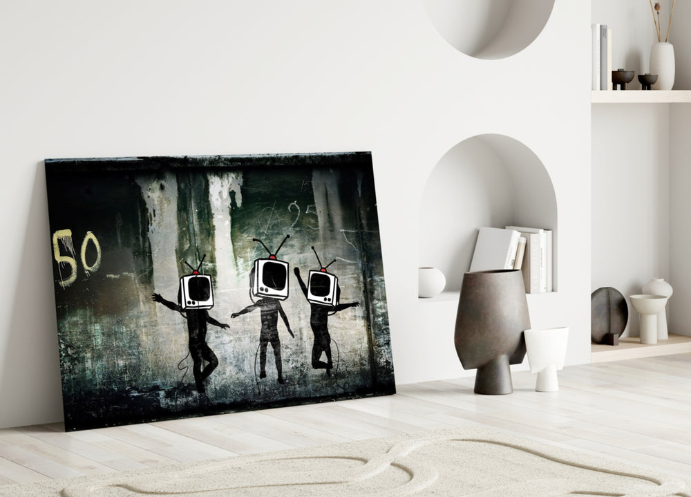 TV Heads close-up showing three TV-set figures dancing on graffitied wall