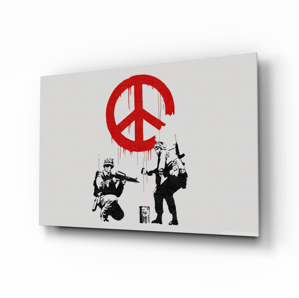 War for Peace glass wall art displayed above a charcoal sofa in a white-walled lounge with steel-frame coffee table and matte-black floor lamp