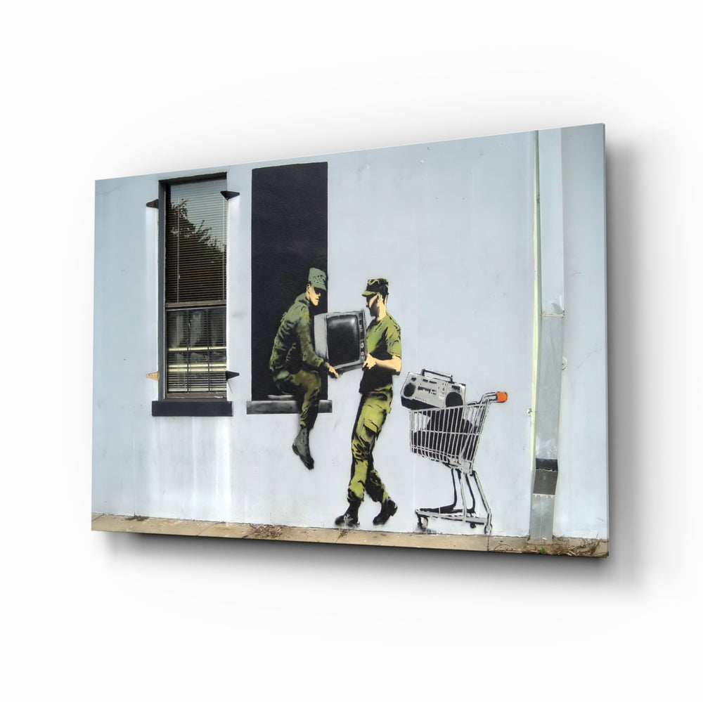 Soldier glass wall art displayed above a charcoal sofa in a chalk-walled office lounge with steel desk and matte-black shelving