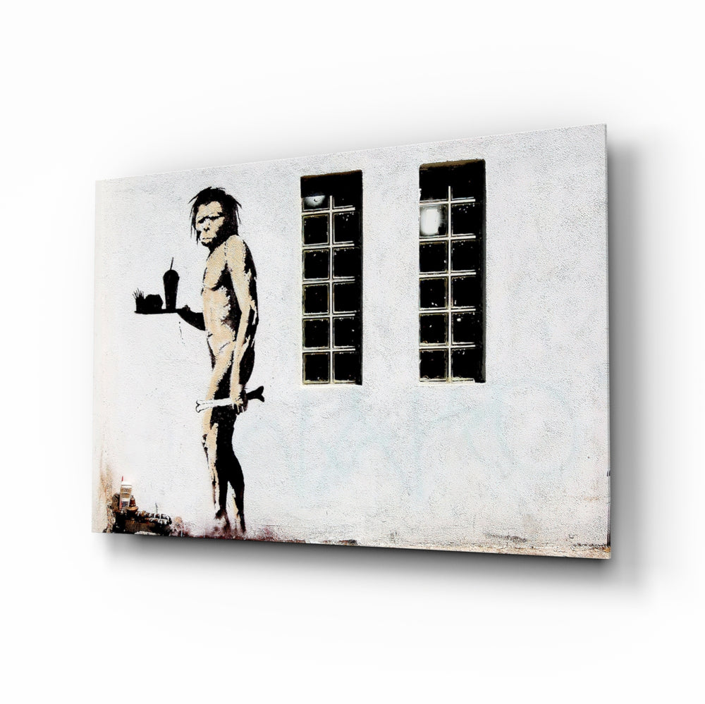 Neanderthal glass wall art displayed above a banquette in a chalk-walled restaurant with marble bistro tables and brass pendant lamps