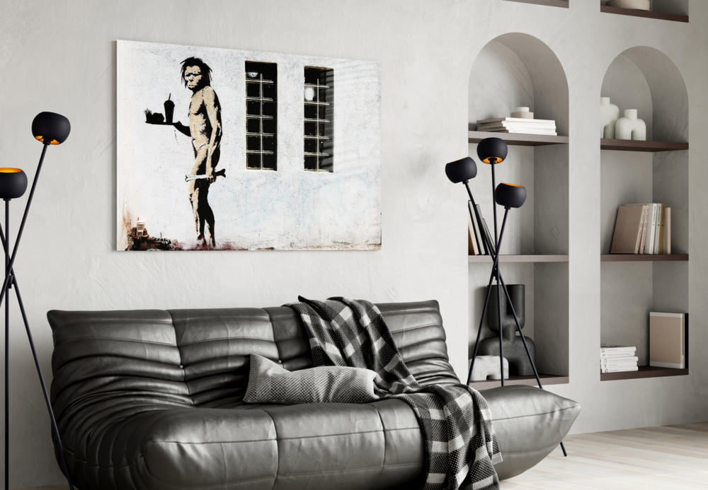Neanderthal glass wall art styled above a sofa in a living room