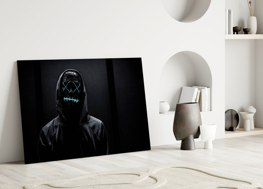Hush and Sight close-up showing hooded figure behind teal-stitched purge mask