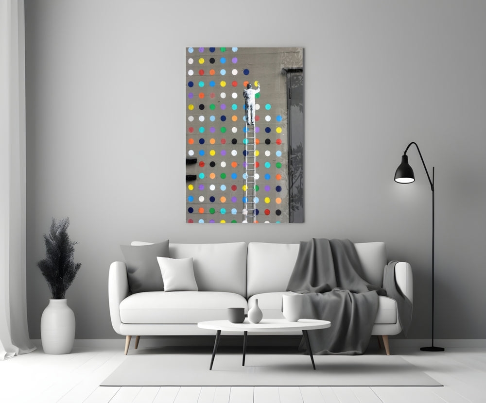 Dots close-up showing stenciled painter on tall ladder filling polka-dot wall