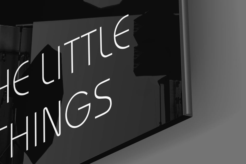 Enjoy The Little Things artwork anchoring a wall with bold motivational palette