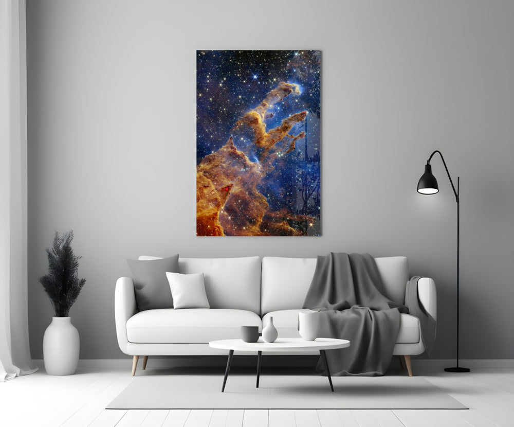 Space close-up showing rust-colored Pillars of Creation among indigo stars