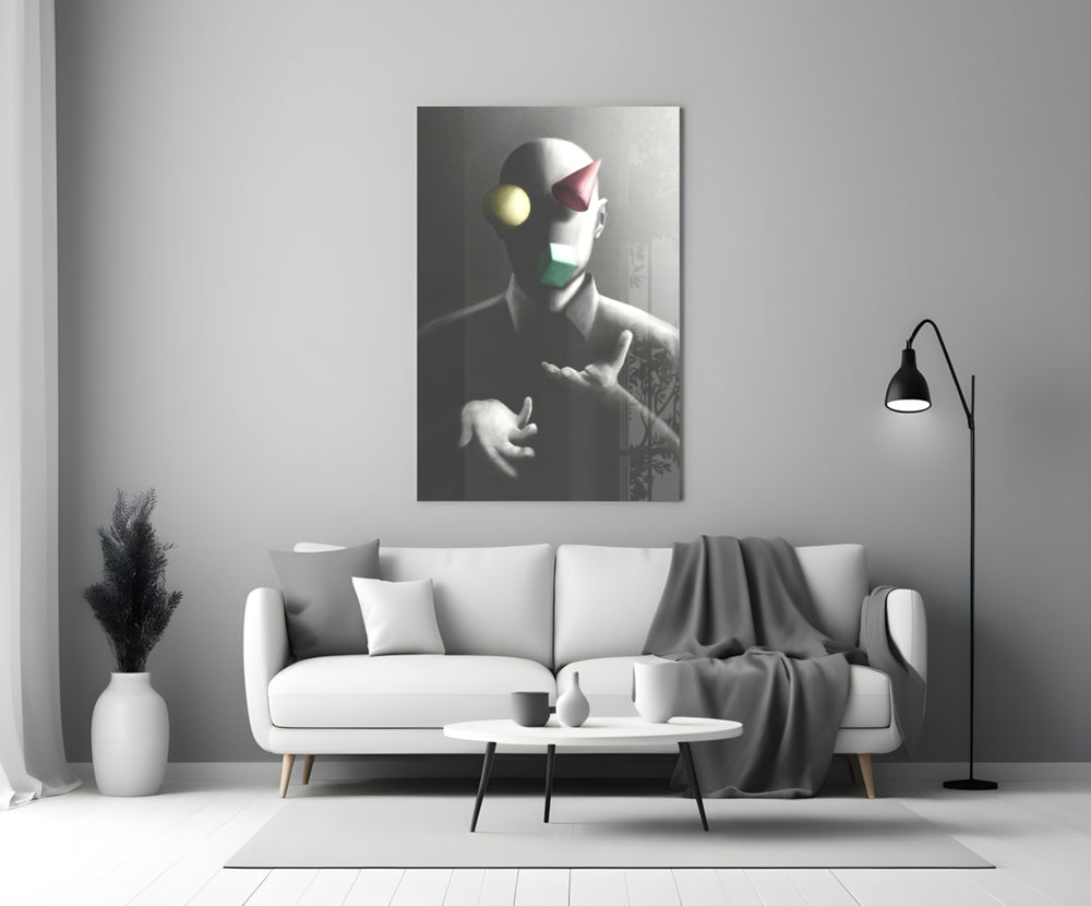 Juggler close-up showing bald figure with floating sphere cone and cube
