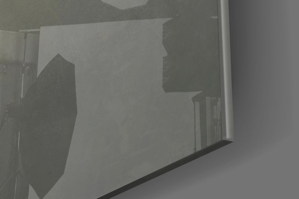 Masks artwork anchoring a wall with moody conceptual palette