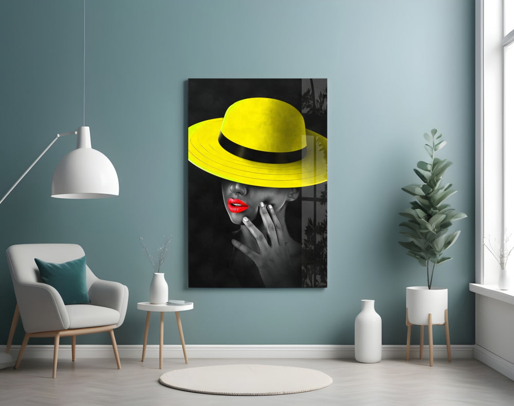 Yellow Hat glass wall art styled above a bed in a bedroom