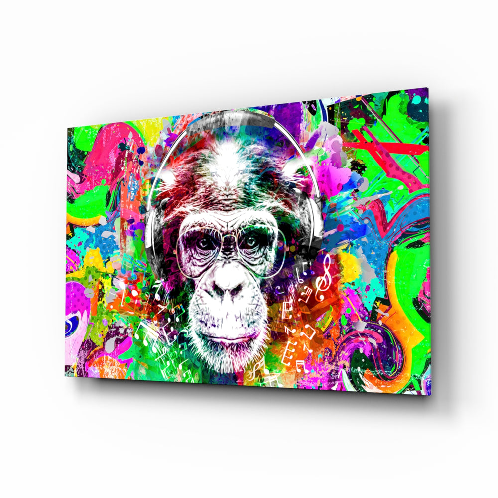 Monkey Face glass wall art displayed above a black gaming sofa in a brick-walled lounge with neon arcade sign and matte-black coffee table