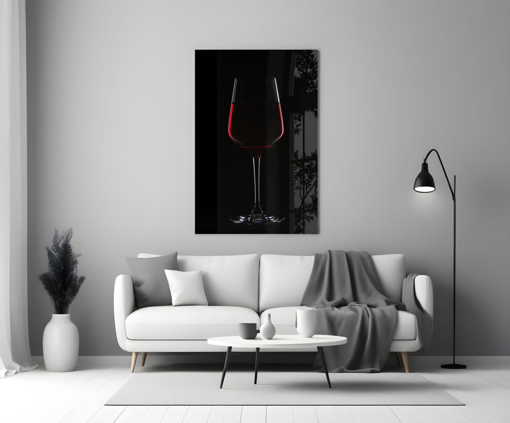 Wine close-up showing long-stem wine glass with garnet pour on onyx