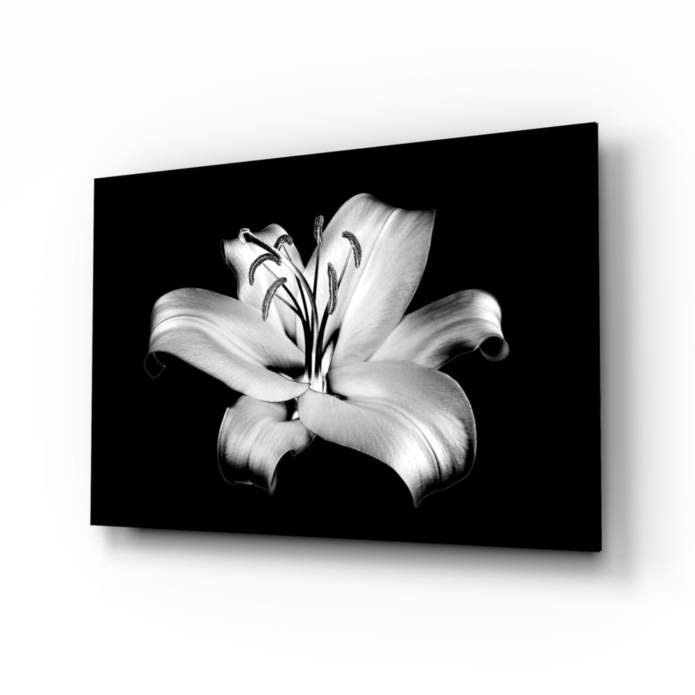 Lilies glass wall art displayed above a charcoal velvet bed in a slate bedroom with brushed-brass sconces and onyx nightstands