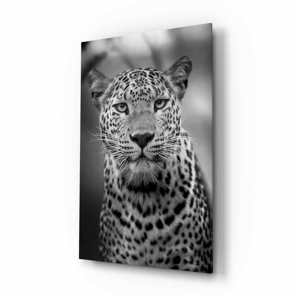 Leopard glass wall art displayed beside a leather chesterfield in a slate-walled man cave with reclaimed-wood console and matte-black floor lamp