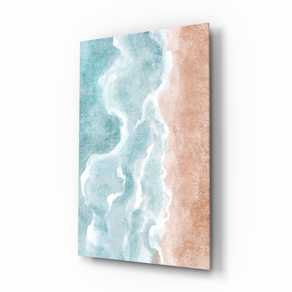 Beach glass wall art displayed above a marble vanity in a coral-walled bathroom with brushed-brass faucet and stoneware tray