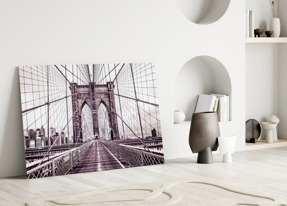 Brooklyn Bridge close-up showing pedestrian walkway and stone tower in sepia mono