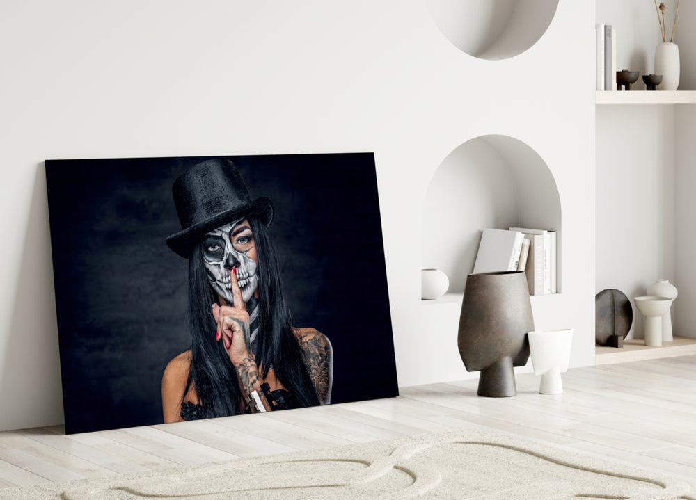 Sssh close-up showing sugar-skull makeup top hat and hush finger gesture