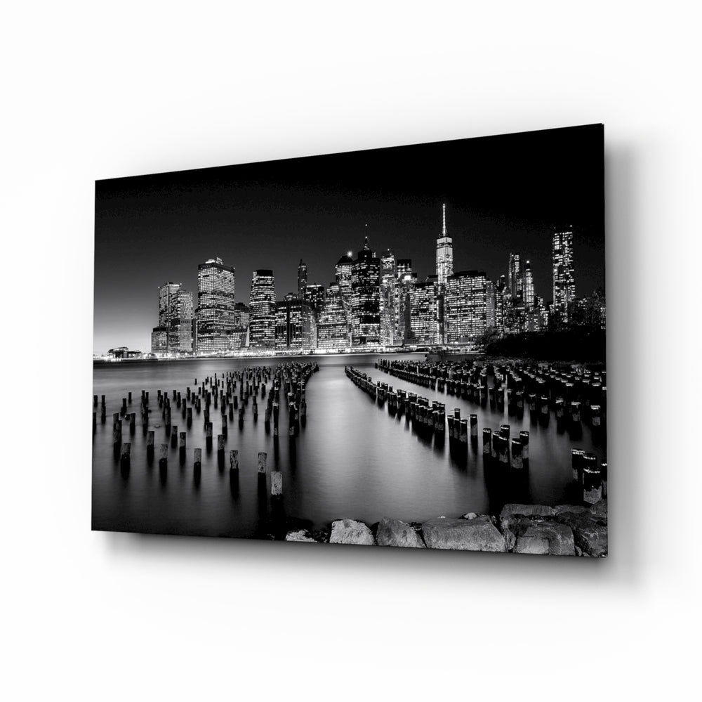City Night glass wall art displayed above a charcoal sofa in a moody living room with walnut console and brass picture light