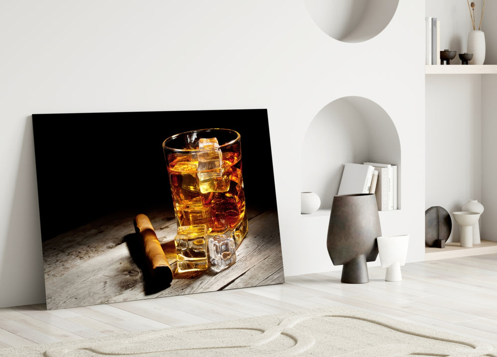 Whiskey close-up showing crystal tumbler with ice and hand-rolled cigar on weathered plank