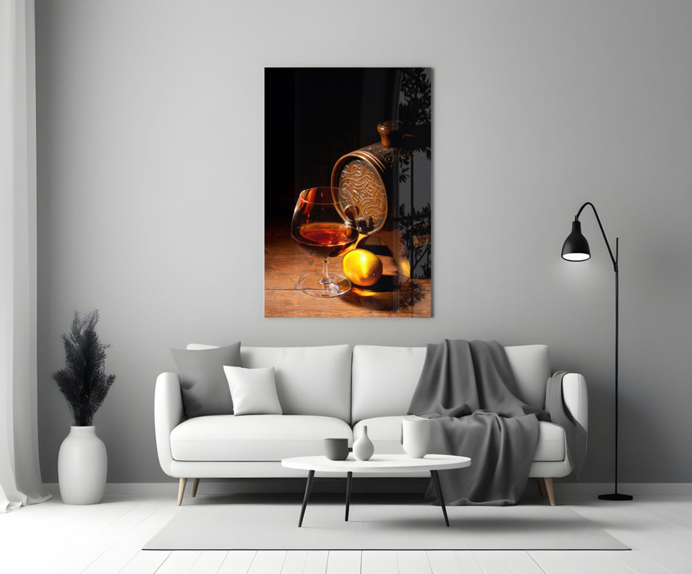 Wine close-up showing cognac tulip glass beside embossed copper barrel and lemon